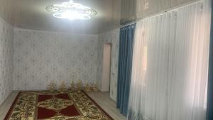 a room with a chandelier and a room with a rug at Мой дом, жилье in Zarger