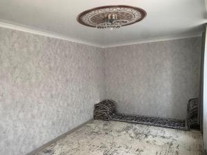 a room with a bed and a chandelier at Мой дом, жилье in Zarger