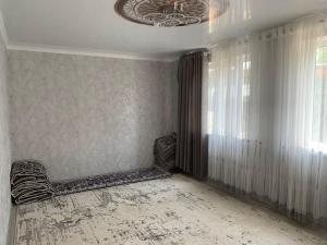 a room with a chair and a ceiling at Мой дом, жилье in Zarger