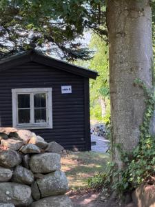 a log cabin with a sign on the window at BAPA STAYs COZY CABIN A by the Ivö lake in Kristianstad