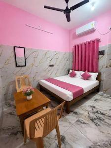 a bedroom with a bed and a table and a table sidx sidx at G3 house Pondicherry in Pondicherry