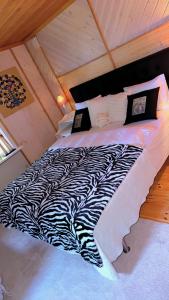 a black and white bed in a attic at BAPA STAYs COZY CABIN A by the Ivö lake in Kristianstad +16 photos