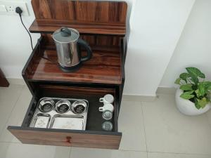 a coffee maker in a wooden box in a kitchen at JIJIVISHA Homestay in Bhīm Tāl