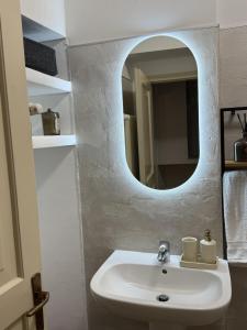 a bathroom with a white sink and a mirror at Siham lake home in Verceia +34 photos