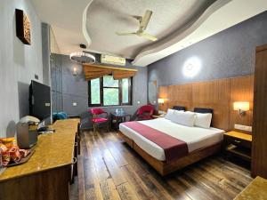 a hotel room with a bed and a desk at Hotel Royal Castle Grand in New Delhi