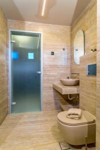 a bathroom with a toilet and a sink at Filian Apartments in Neos Marmaras +39 photos