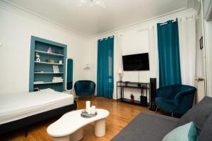 a room with a bed and two chairs and a table at Hyper Centre Place Kléber Appart in Strasbourg