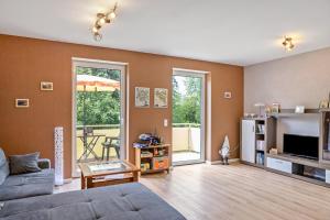 a living room with a couch and a tv at Ferienwohnung "Beim Tannenbaum" in Reichensachsen