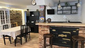 a kitchen with a bar and a table with chairs at Casa Olga in Lanestosa