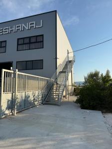 a building with a staircase in front of it at The Factory Boutique in Vlorë