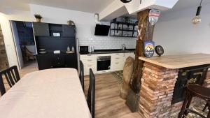 a kitchen and dining room with a table and a fireplace at Casa Olga in Lanestosa