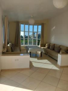 a living room with a couch and a table at Mediterraneo House in Tangier