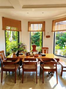a dining room with a large wooden table and chairs at 宣萱民宿 in Mile +17 photos