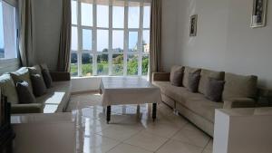 a living room with a couch and a table at Mediterraneo House in Tangier