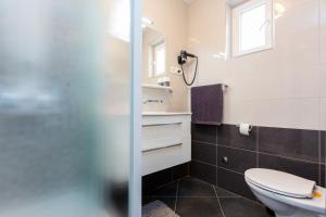 a bathroom with a toilet and a shower at Guesthouse Ivona in Dubrovnik