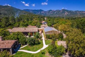 an aerial view of a house with mountains in the background at Hôtel Casanghjulina in Porto-Vecchio