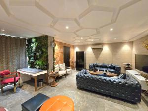 a living room with a couch and a table at Hotel Royal Castle Grand in New Delhi +34 photos