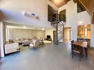 a living room with a couch and a staircase at Apex Hills تلال القمة in Dār Sawdāʼ