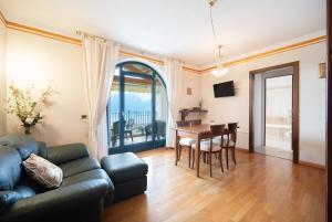 a living room with a couch and a table at ApartmentsGarda - Villa Giada in Torri del Benaco