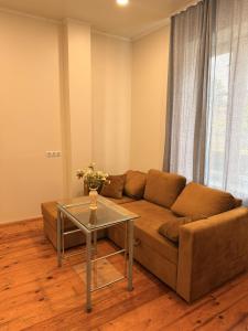 a living room with a couch and a glass table at LIINA apartment in Vahtseliina