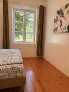 a bedroom with a bed and a window at LIINA apartment in Vahtseliina