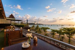 a restaurant with a view of the ocean at Baywalk Residence Pattaya in Pattaya