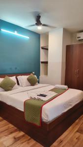 a bedroom with a large bed with a blue wall at RLV green palace in Bangalore