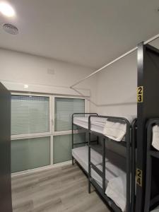 a room with two bunk beds in it at Albergue Adventus in Padrón