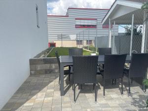 a black table and chairs on a patio at Ferienwohnung Mina in Münsingen