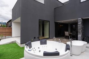 a bathroom with a bath tub on a patio at The Terrace MAKINO in Takashima