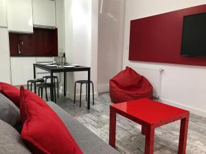 a living room with a couch and a red table at Smart-Tech Plaza Apartment in Salamanca