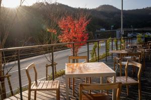 a row of tables and chairs on a balcony with a road at Fairfield by Marriott Kyoto Kyotamba in Nantan city