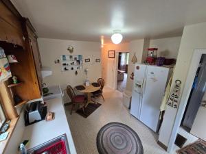 a kitchen with a table and a refrigerator at Yellow Barn House in Danbury +17 photos