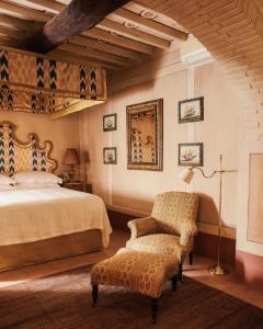 a bedroom with a bed and a chair at Le Lappe in Cavriglia +87 photos