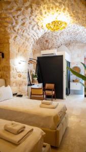 a room with two beds and a flat screen tv at Konak Zenobia in Midyat