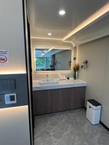 a bathroom with a sink and a large mirror at Nx Space พลูวิลล่า in Nakhon Nayok +53 photos