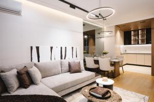 a living room with a couch and a table at CIA apartmani - Arandjelovac Bekatown Apartment in Arandelovac