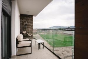 a balcony with a view of a tennis court at CIA apartmani - Arandjelovac Bekatown Apartment in Arandelovac