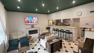 a living room with a couch and a bar at La Canopée in La Gouesnière