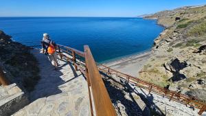 a person walking up a stairway looking at the ocean at Casa Las Conchas in La Rábita