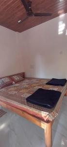a bed in a room with a ceiling at Serina Guest House Malvan in Malvan +2 photos