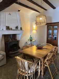 a dining room with a wooden table and a fireplace at Casa el Estanco in Barracas