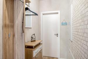 a bathroom with a white door and a white brick wall at Ferienwohnung "Beim Tannenbaum" in Reichensachsen +18 photos