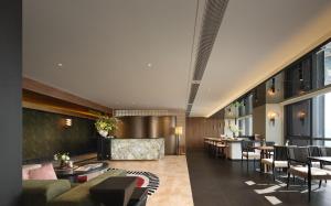 a lobby of a hotel with tables and chairs at Aranciel 阿岚若 High-Rise River View Hotel -Jiefangbei Area-Hongya Cave in Chongqing