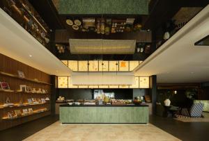 a lobby of a restaurant with a counter in a room at Aranciel 阿岚若 High-Rise River View Hotel -Jiefangbei Area-Hongya Cave in Chongqing
