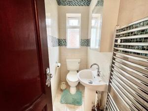 a bathroom with a toilet and a sink at Spacious Double Room In Central Stoke in Stoke on Trent