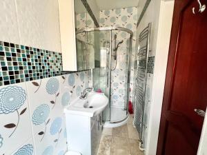 a bathroom with a sink and a shower at Spacious Double Room In Central Stoke in Stoke on Trent