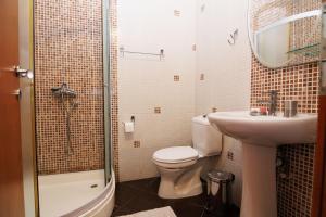 a bathroom with a toilet and a sink and a shower at Apartments Stevo Nikočević in Bar +108 photos