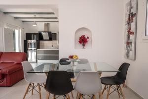 a living room with a glass table and chairs at Villa Verde with Outdoor Jacuzzi in Divarata