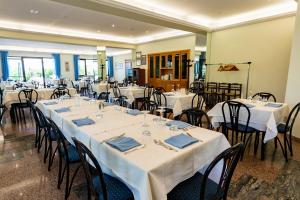 a room with tables and chairs with white tablecloths at Da Micchele Rooms in Vasto